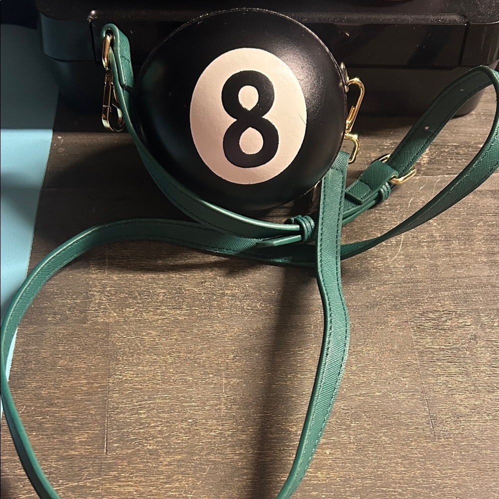 Black 8-Ball Round Crossbody Bag with Green Strap